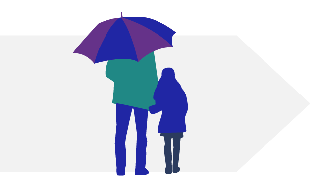 Adult holding umbrella and holding hands with a child